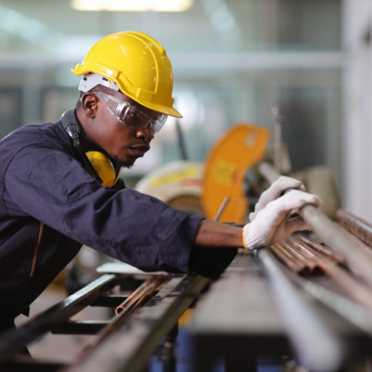 Male manufacturing worker in yellow helmet